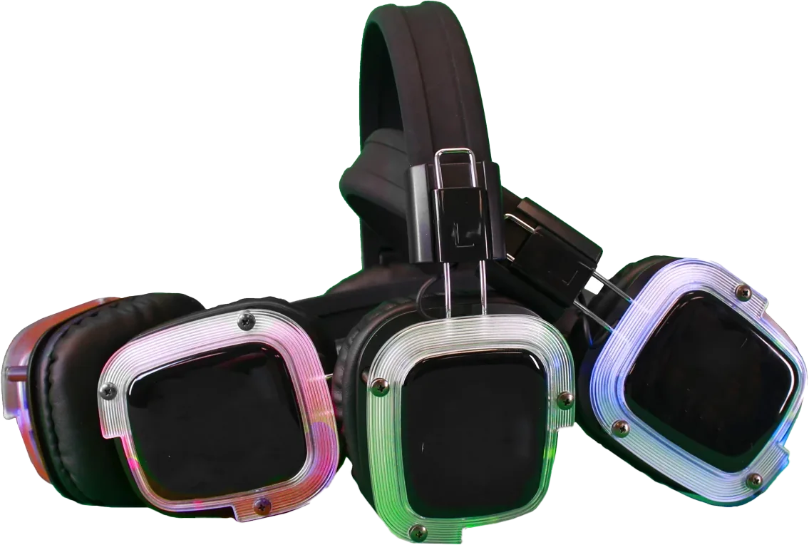Three silent disco headsets with their ear cups lit in different colours — pink, green and blue — one colour for each of the three channels.